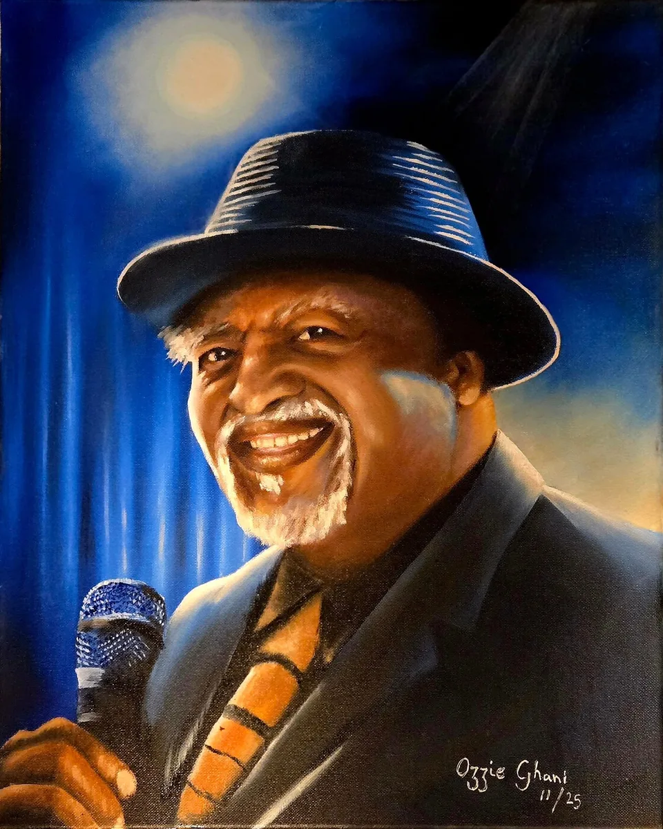 Oil portrait of Danny Armstrong smiling on stage with a microphone under blue jazz and blues lighting, painted by Ozzie Ghani in 2025.